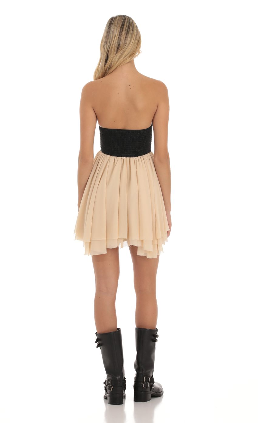 Picture Faux Leather Ruched Fit and Flare Dress in Cream and Black. Source: https://media-img.lucyinthesky.com/data/Oct23/850xAUTO/1b93dd39-544d-4f43-9ce7-8e4826b5f6b5.jpg