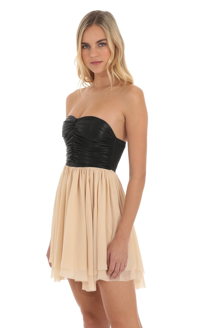 Picture Faux Leather Ruched Fit and Flare Dress in Cream and Black. Source: https://media-img.lucyinthesky.com/data/Oct23/850xAUTO/daf23f93-32ba-4e1b-bd4c-8e0a8ca468bd.jpg