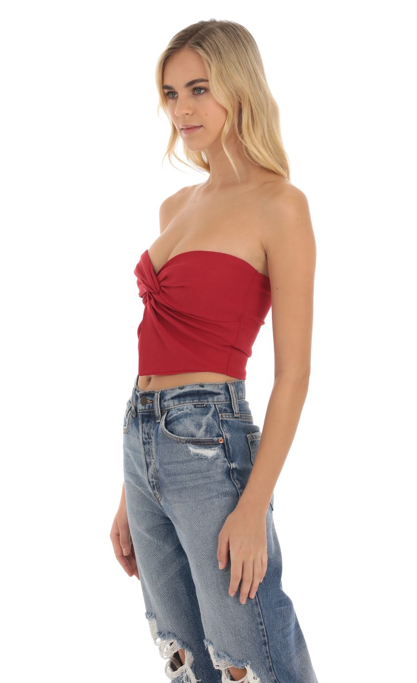 Picture Strapless Twist Top in Red. Source: https://media-img.lucyinthesky.com/data/Oct23/850xAUTO/e6dc3d46-3cf0-46c4-ad17-b9011015b3a2.jpg
