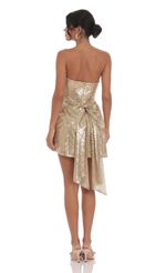 Picture Sequin Attachable Bow Dress in Gold. Source: https://media-img.lucyinthesky.com/data/Oct24/150xAUTO/773ffd17-4a57-4feb-82cb-af6db53fcb93.jpg