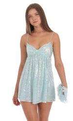 Picture Sequin Front Bow Babydoll Dress in Seafoam Blue. Source: https://media-img.lucyinthesky.com/data/Oct24/150xAUTO/cd15b050-c861-44c3-a78c-eb19d3a7a31a.jpg