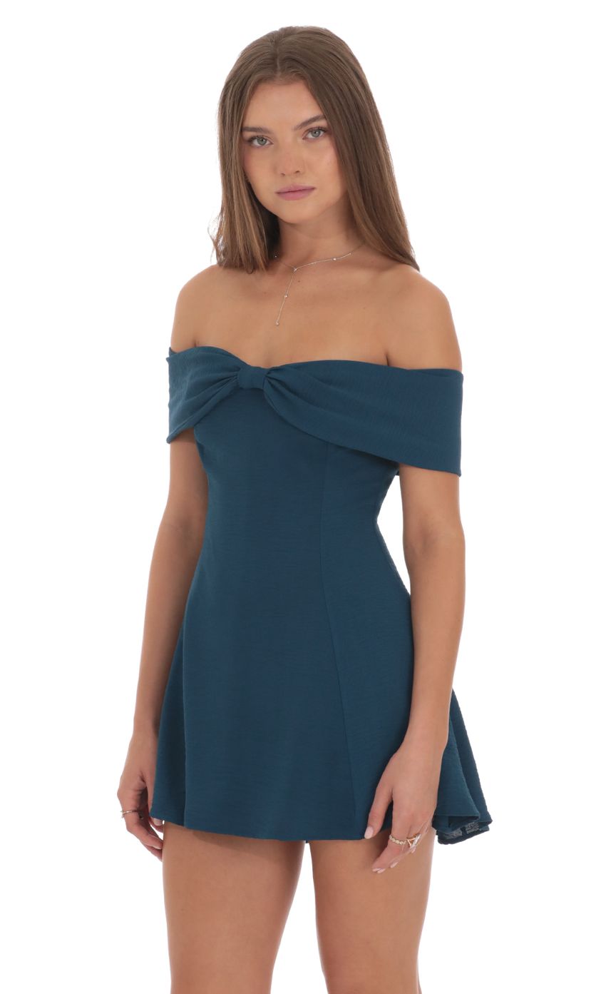 Picture Front Bow Off Shoulder Dress in Dark Teal. Source: https://media-img.lucyinthesky.com/data/Oct24/850xAUTO/1cb88a53-8bcb-41af-9df6-137290b12543.jpg