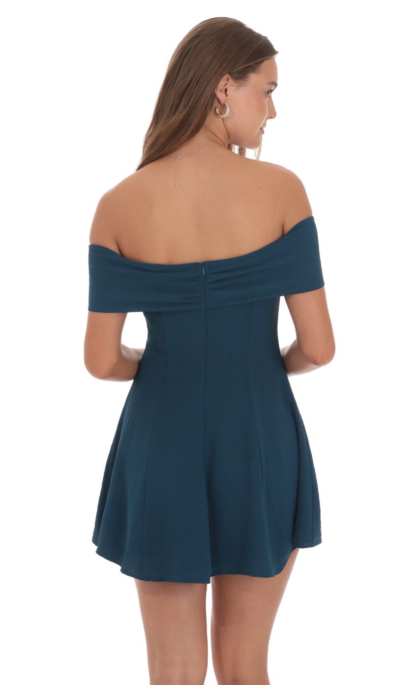 Picture Front Bow Off Shoulder Dress in Dark Teal. Source: https://media-img.lucyinthesky.com/data/Oct24/850xAUTO/bb8fae29-4513-4ed2-93be-d2416c1a6d91.jpg