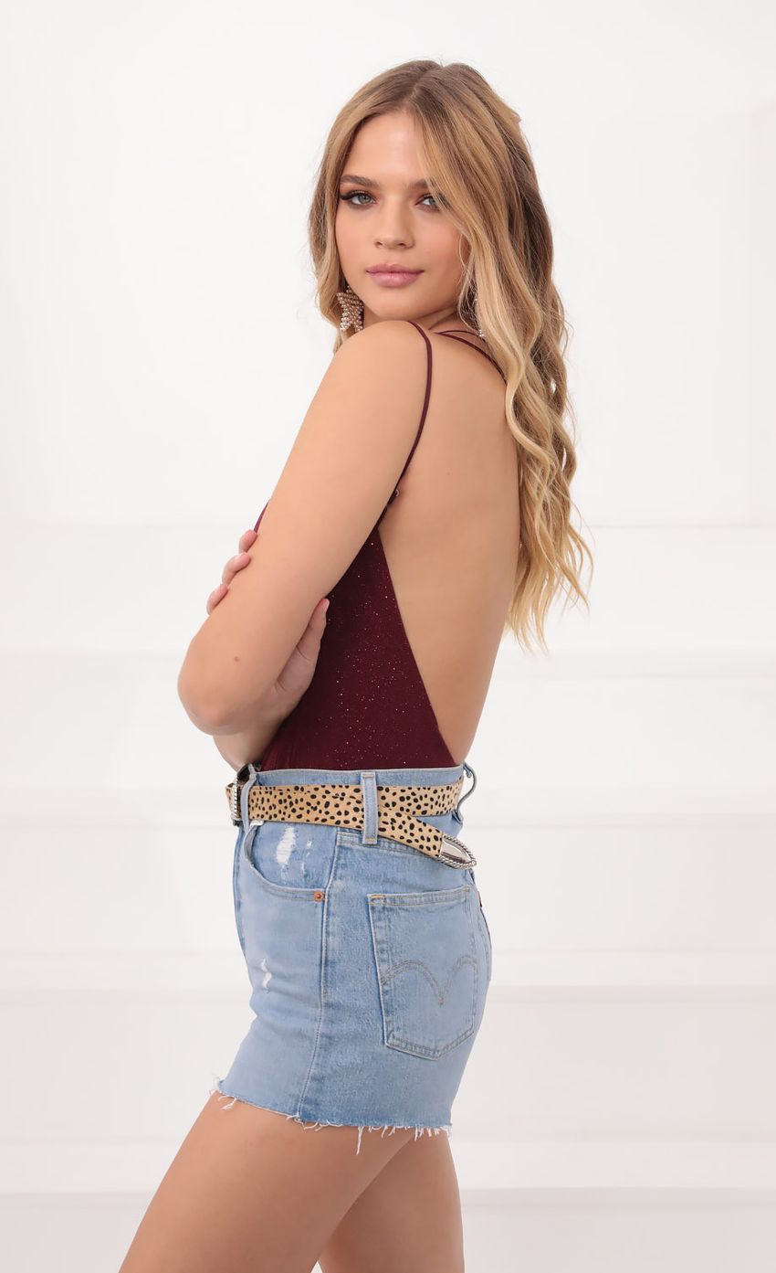Picture One Shoulder Shimmer Bodysuit in Burgundy. Source: https://media-img.lucyinthesky.com/data/Sep20_1/850xAUTO/781A0513.JPG