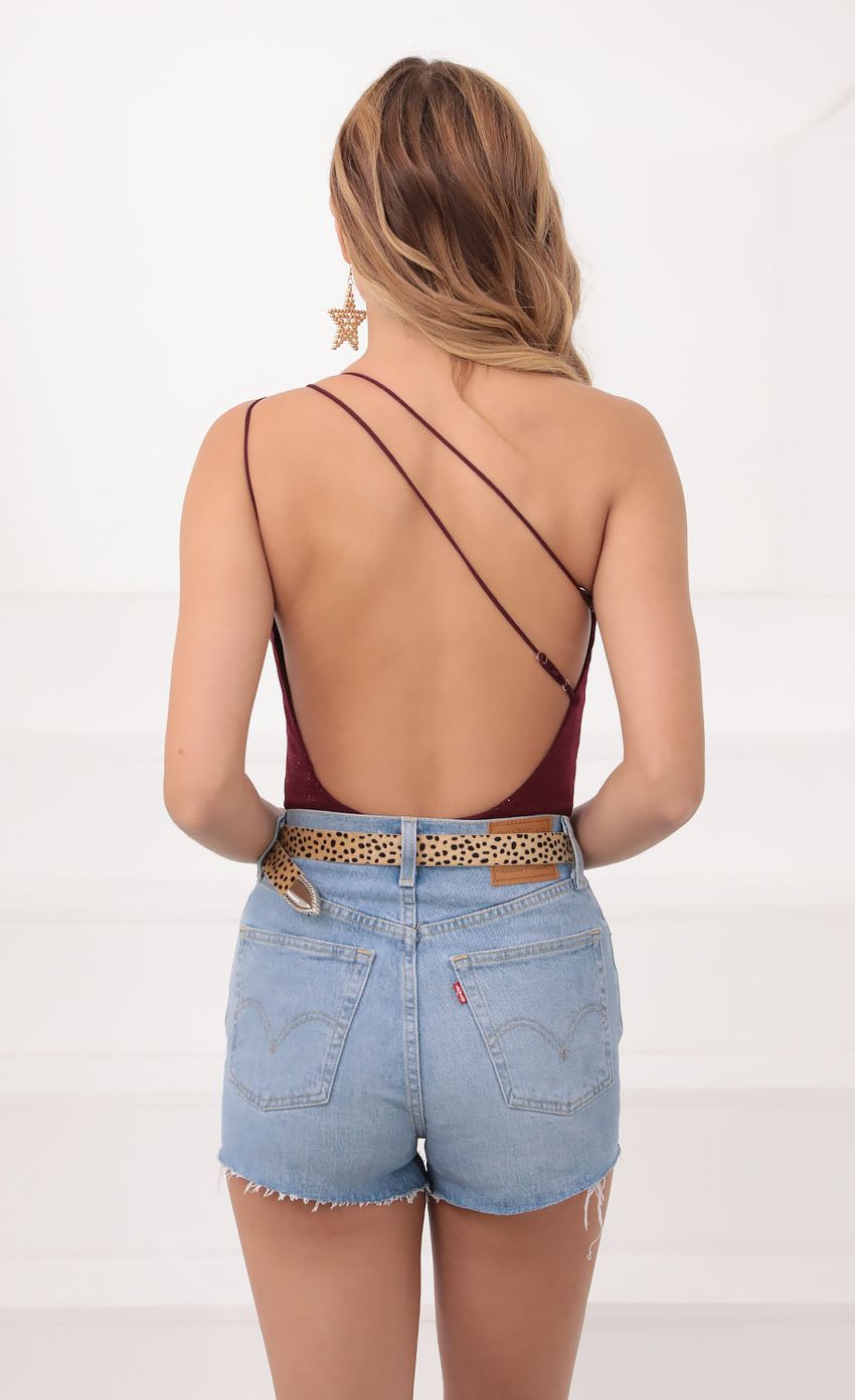 Picture One Shoulder Shimmer Bodysuit in Burgundy. Source: https://media-img.lucyinthesky.com/data/Sep20_1/850xAUTO/781A05181.JPG