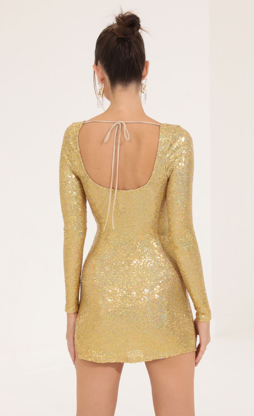 Picture Iridescent Sequin Long Sleeve Dress in Gold. Source: https://media-img.lucyinthesky.com/data/Sep22/850xAUTO/57b3430b-204e-477d-81a4-639800abca4b.jpg