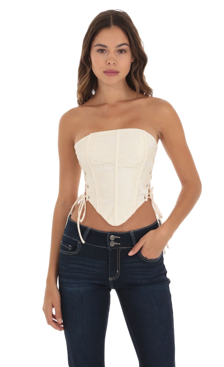Picture Embroidered Corset Top in Cream. Source: https://media-img.lucyinthesky.com/data/Sep23/850xAUTO/7f20aa74-eb0f-4ac1-83d5-b98ef54b9c59.jpg