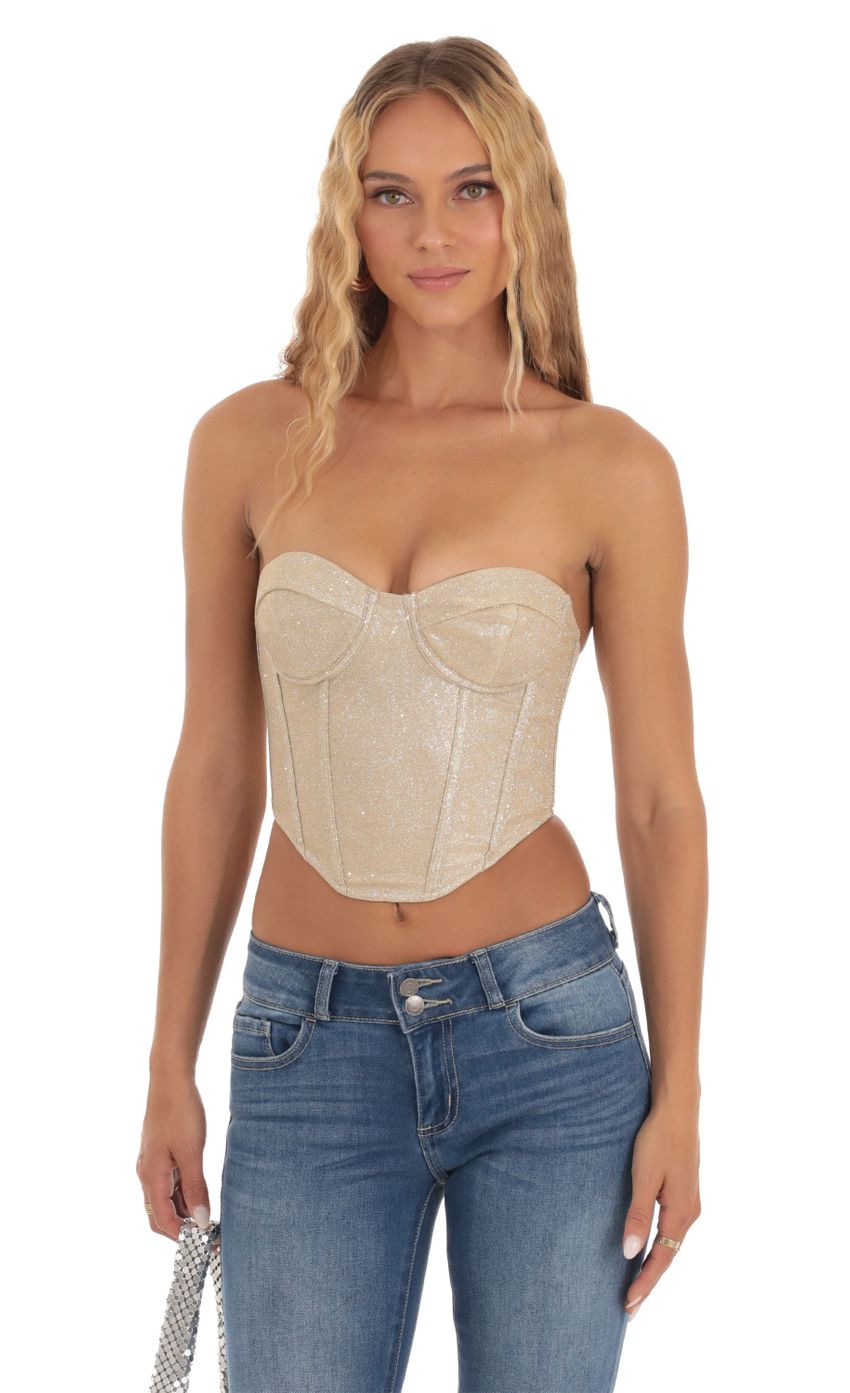 Picture Shimmer Corset Top in Gold. Source: https://media-img.lucyinthesky.com/data/Sep23/850xAUTO/9c0477ca-2e68-433a-9d7d-82f6c1be8d3b.jpg