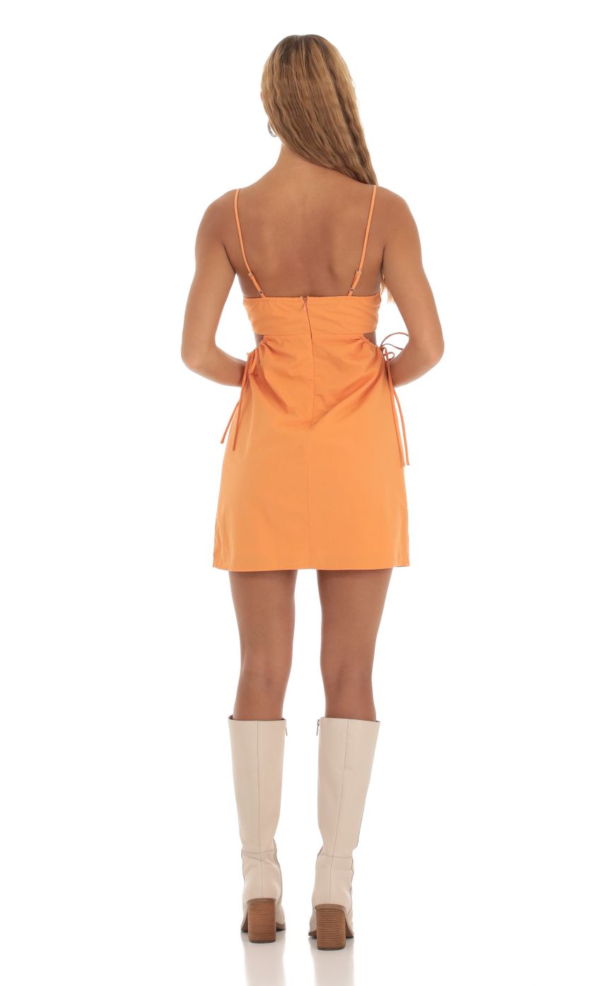 Picture Side Cutout Dress in Orange. Source: https://media-img.lucyinthesky.com/data/Sep23/850xAUTO/e5b68062-966d-4fbb-a38a-71ab08dbbf1e.jpg