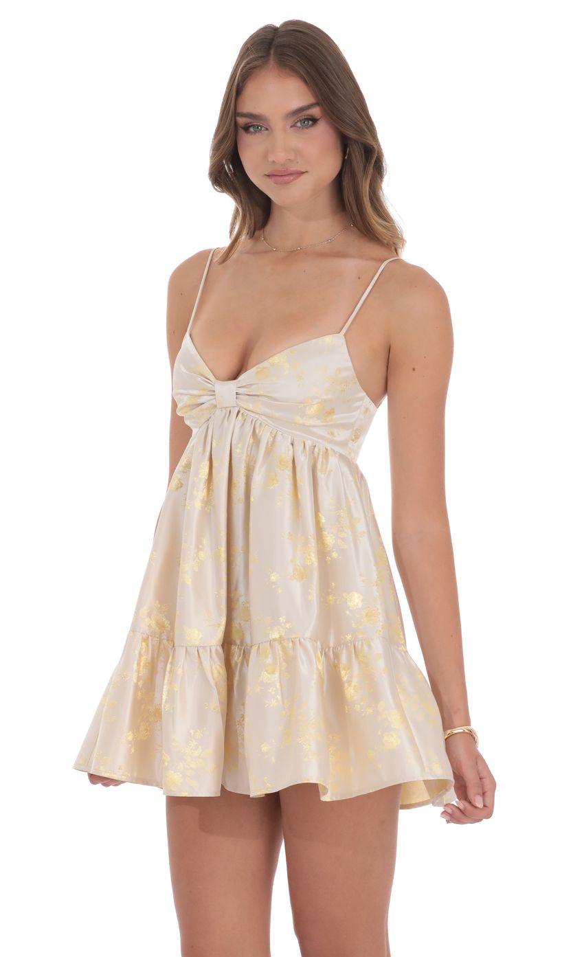 Picture Foiled Bow Babydoll Dress in Champagne. Source: https://media-img.lucyinthesky.com/data/product-media/850xAUTO/01eefa11-79e5-48be-af66-fde4992f5f51.jpg