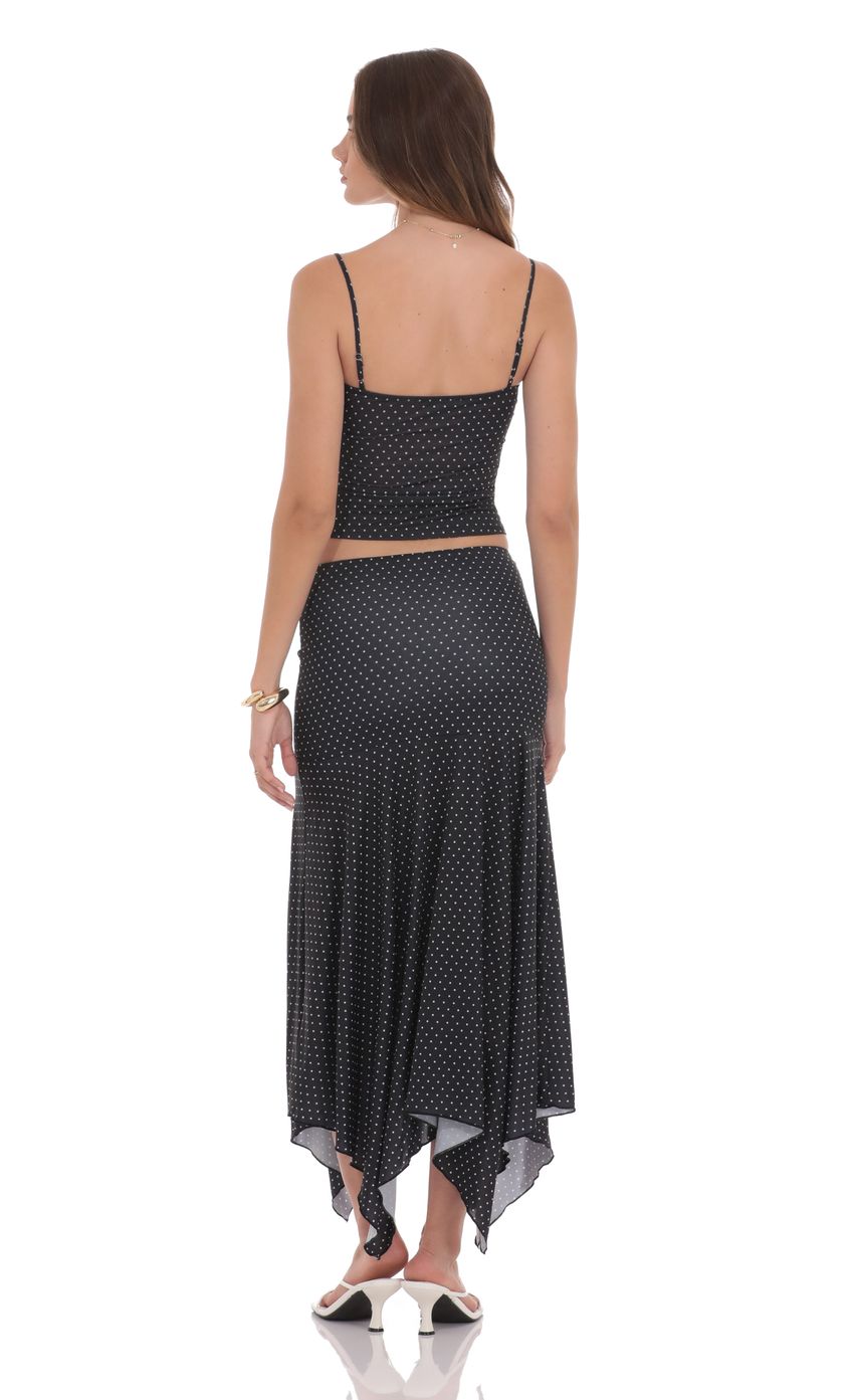 Picture Polka Dot Asymmetrical Maxi Skirt in Black. Source: https://media-img.lucyinthesky.com/data/product-media/850xAUTO/0caf3899-dfcc-49b2-a6b8-2de5a72f1364.jpg