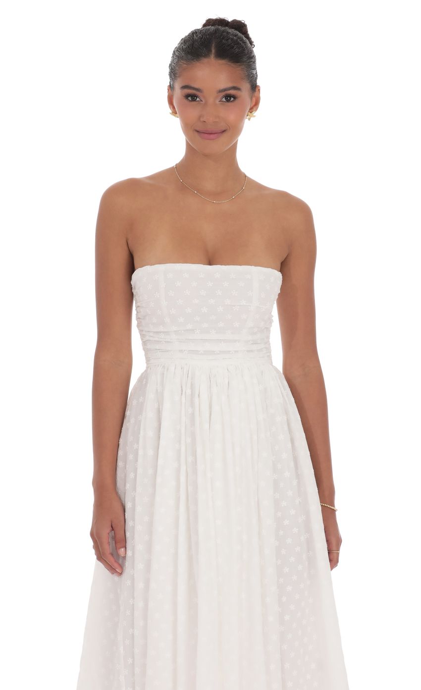 Picture Floral Back Bow Midi Dress in White. Source: https://media-img.lucyinthesky.com/data/product-media/850xAUTO/0e112f87-895d-4d94-bdc1-a09cef33115a.jpg