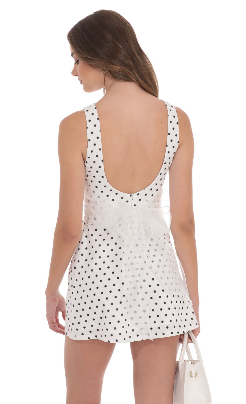 Picture Polka Dot High Neck Back Bow Dress in White. Source: https://media-img.lucyinthesky.com/data/product-media/850xAUTO/0f78b11e-8760-41f9-a68a-a56327b6a2f9.jpg