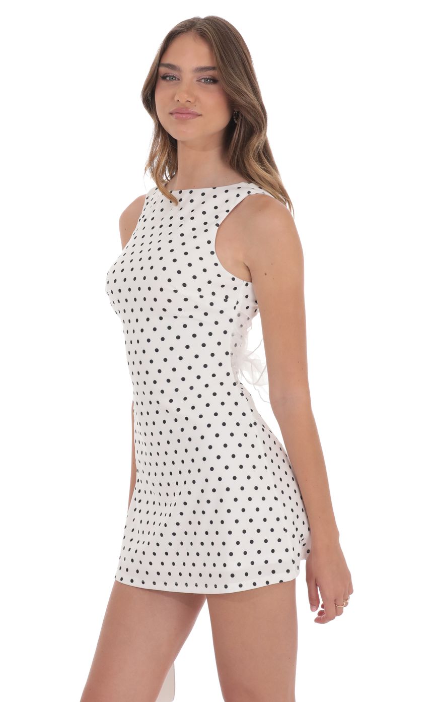 Picture Polka Dot High Neck Back Bow Dress in White. Source: https://media-img.lucyinthesky.com/data/product-media/850xAUTO/102edf26-9671-4dc7-bb0a-2b76938fb831.jpg