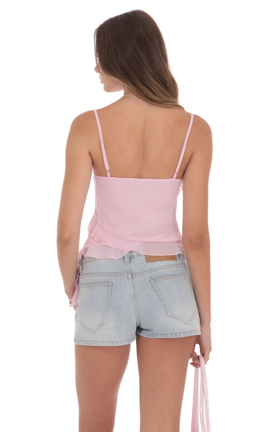 Picture Ruffle Tassel Top in Pink. Source: https://media-img.lucyinthesky.com/data/product-media/850xAUTO/152434b5-3b34-4740-9b69-5087fa84dc75.jpg