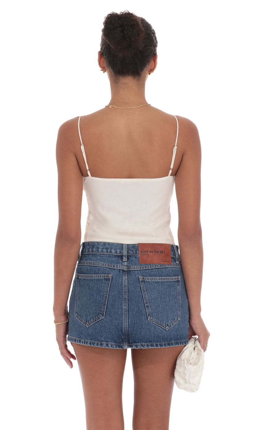 Picture Mesh Front Tassel Top in Ivory. Source: https://media-img.lucyinthesky.com/data/product-media/850xAUTO/3515e867-f6a0-4ca8-bf47-54dec8cea797.jpg