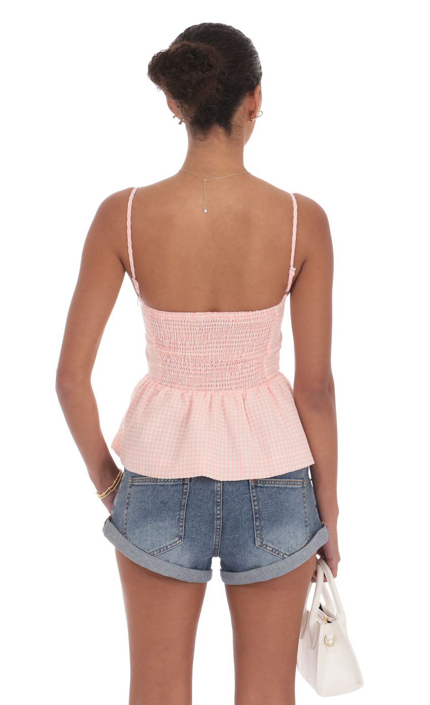 Picture Gingham Peplum Top in Pink. Source: https://media-img.lucyinthesky.com/data/product-media/850xAUTO/55dec6f0-029a-42bc-87fe-2f2826579f39.jpg