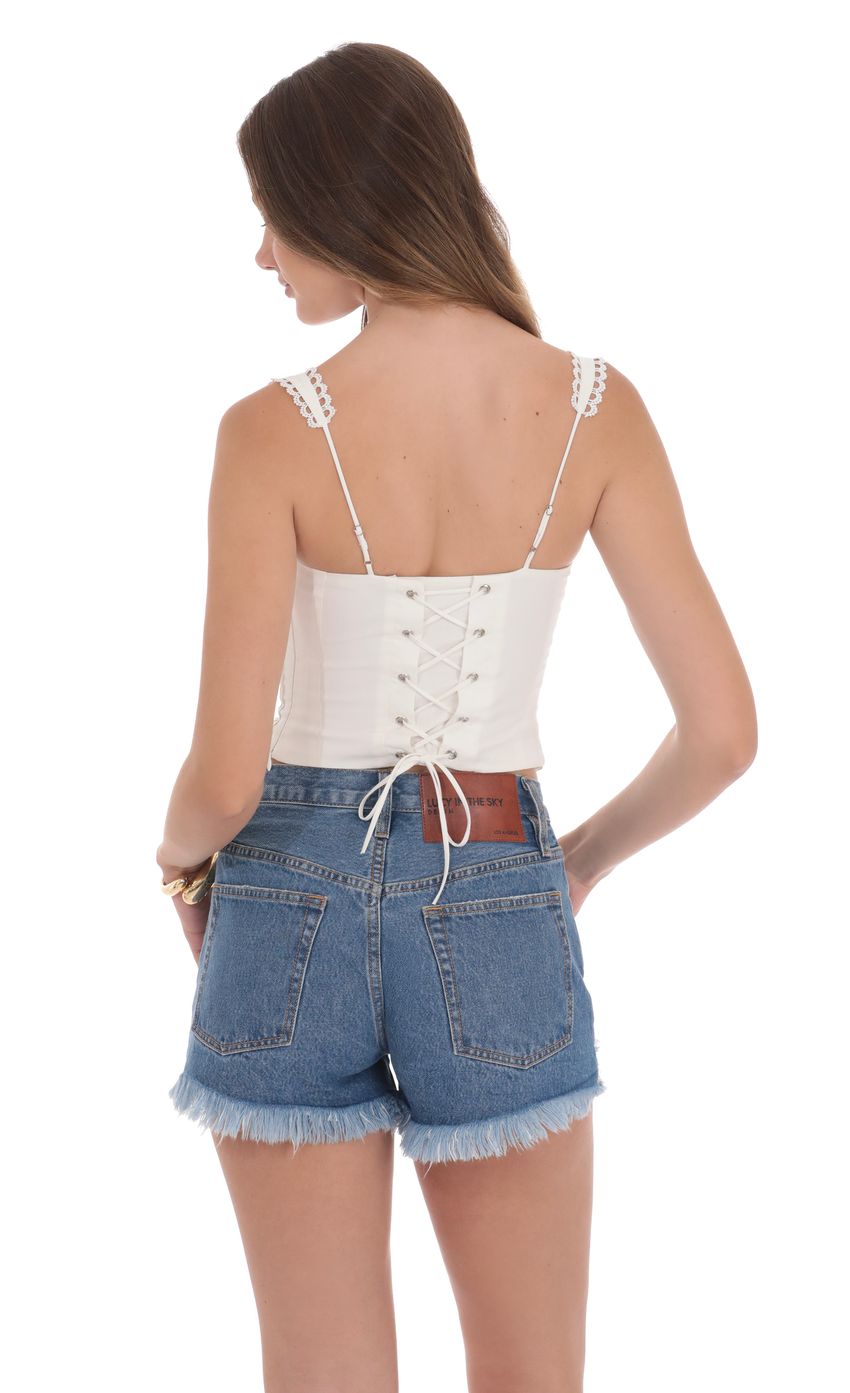 Picture Distressed High Waisted Denim Shorts in Blue. Source: https://media-img.lucyinthesky.com/data/product-media/850xAUTO/59ff303f-6af5-44c4-a3d5-8f3b48736aa9.jpg