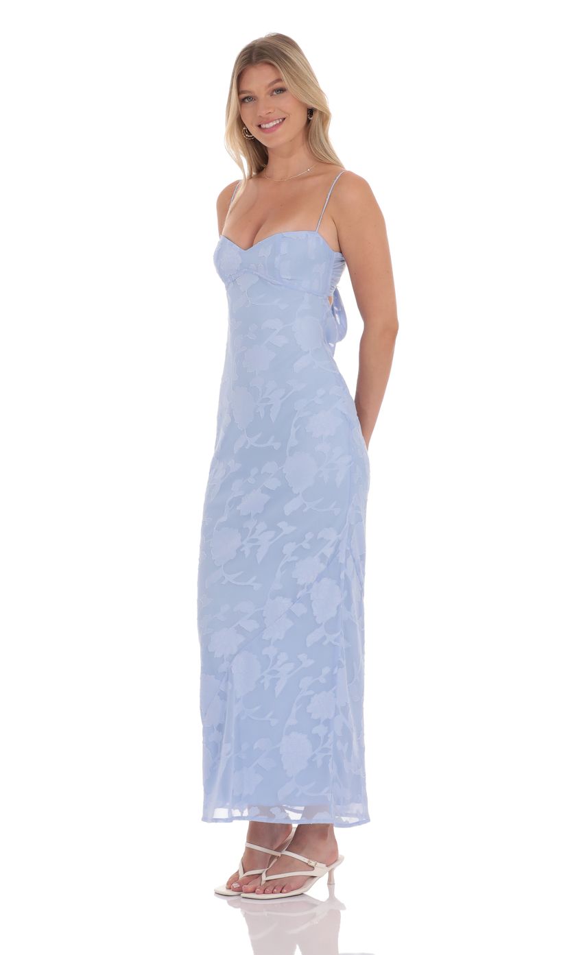 Picture Floral Back Tie Maxi Dress in Light Blue. Source: https://media-img.lucyinthesky.com/data/product-media/850xAUTO/6609bde4-6003-4cb6-84de-04a997d63dd3.jpg