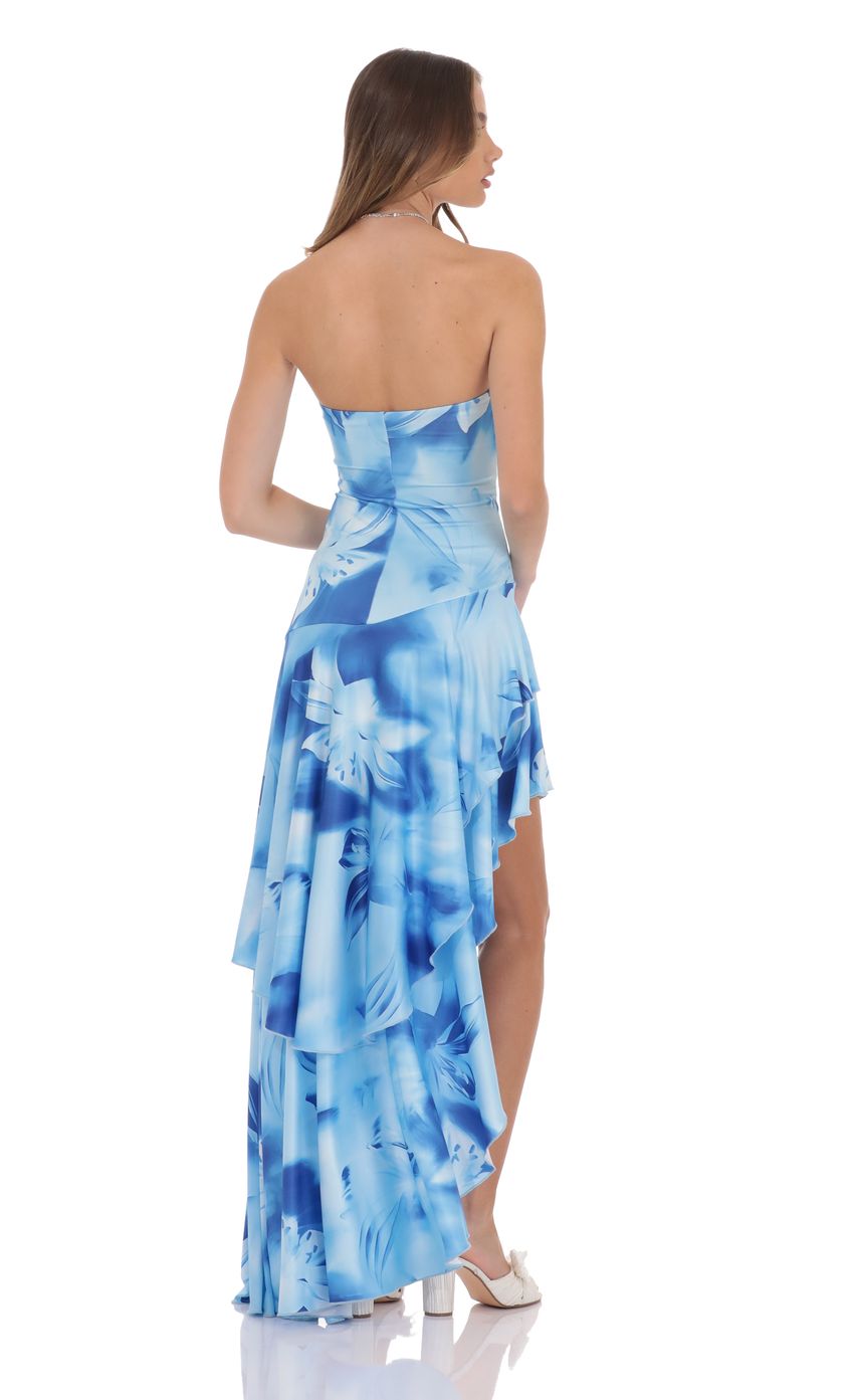 Picture Floral Strapless Ruffle Asymmetrical Maxi Dress in Blue. Source: https://media-img.lucyinthesky.com/data/product-media/850xAUTO/6805f271-2e43-4613-a4ac-6e851aaec2b7.jpg