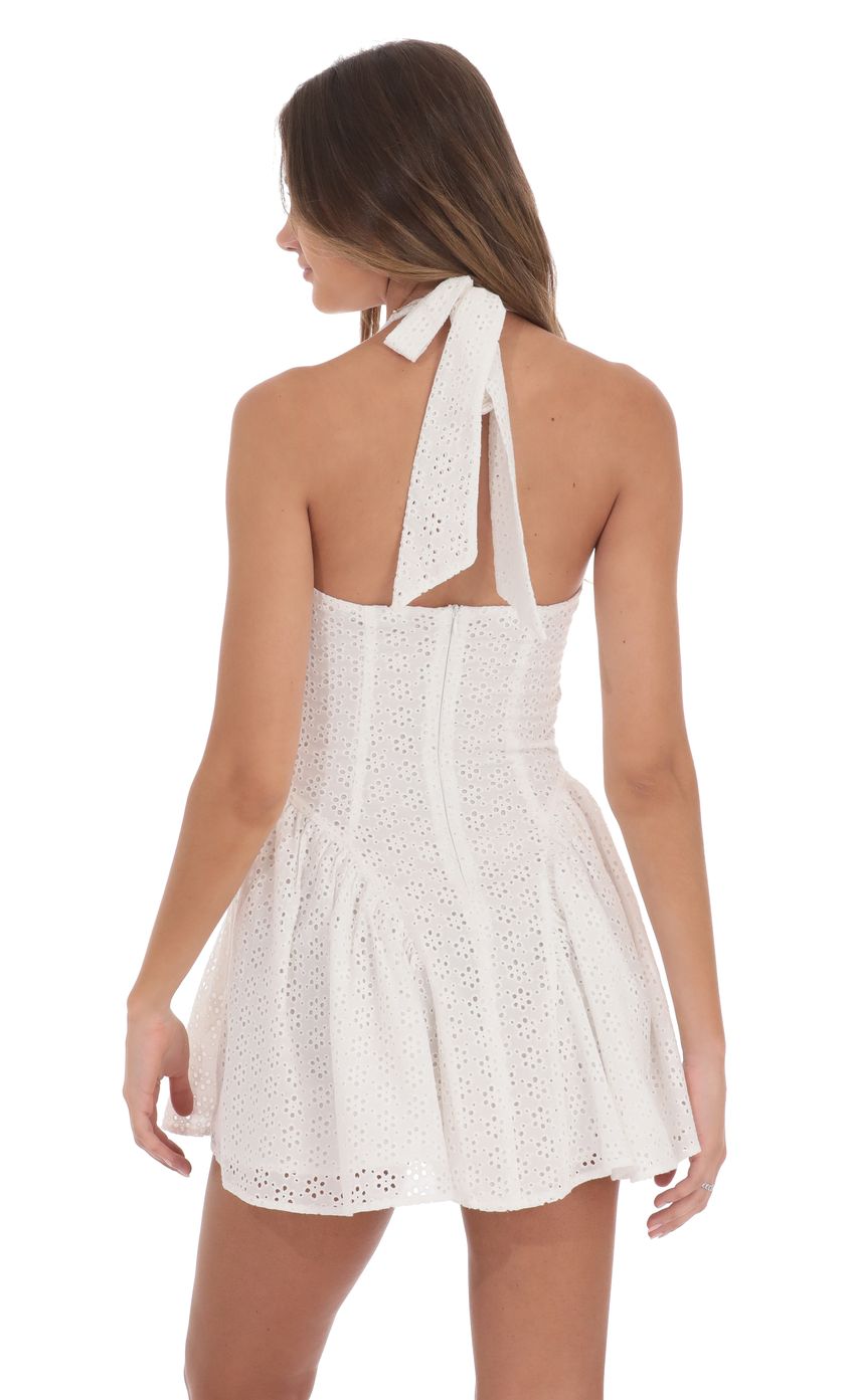 Picture Floral Eyelet Halter Dress in White. Source: https://media-img.lucyinthesky.com/data/product-media/850xAUTO/79a994b5-e81e-406f-9639-56dfdaf973a8.jpg