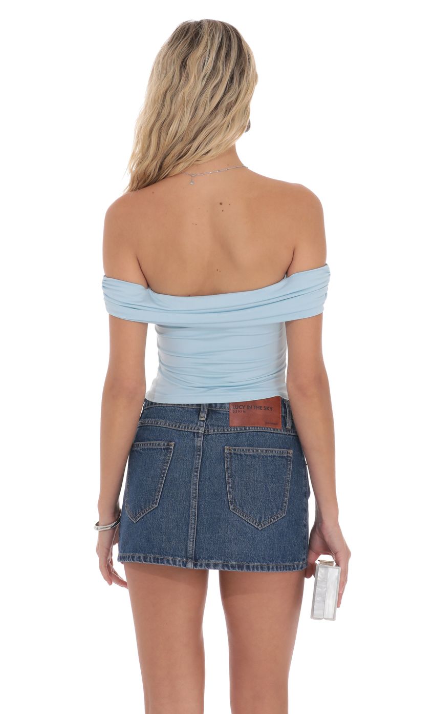 Picture Embellished Off Shoulder Top in Light Blue. Source: https://media-img.lucyinthesky.com/data/product-media/850xAUTO/7c9241c6-f8b5-4978-826b-8f517334bed3.jpg