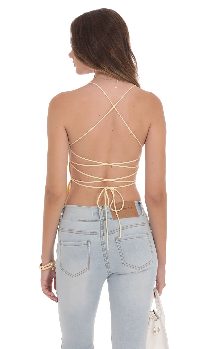 Picture Open Back Lace Top in Yellow. Source: https://media-img.lucyinthesky.com/data/product-media/850xAUTO/87eddf23-bbc2-4c5d-8786-7d40b0508a5c.jpg