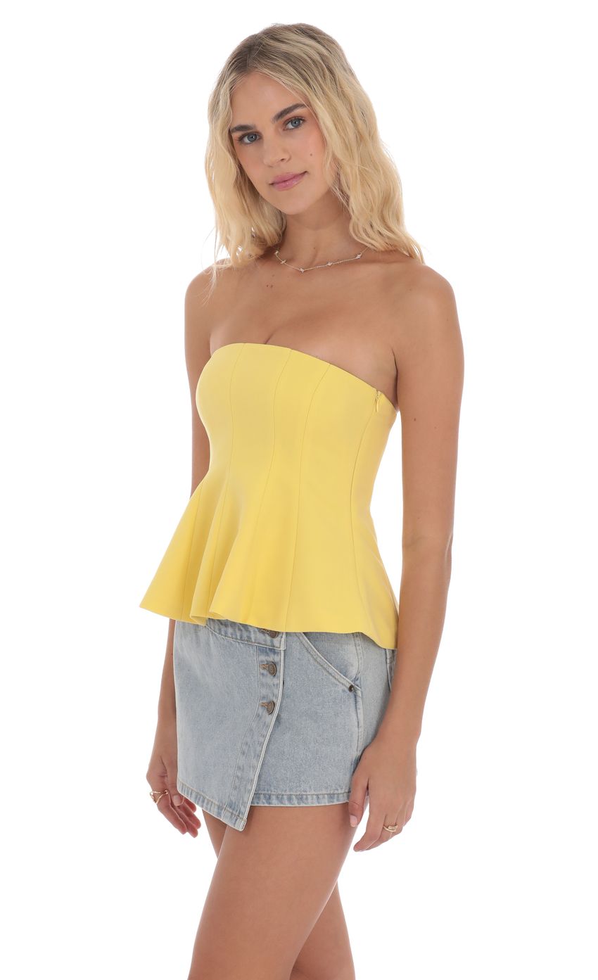 Picture Strapless Peplum Top in Yellow. Source: https://media-img.lucyinthesky.com/data/product-media/850xAUTO/93dfdd55-73c6-45bf-aaa2-fe837c01e2c8.jpg