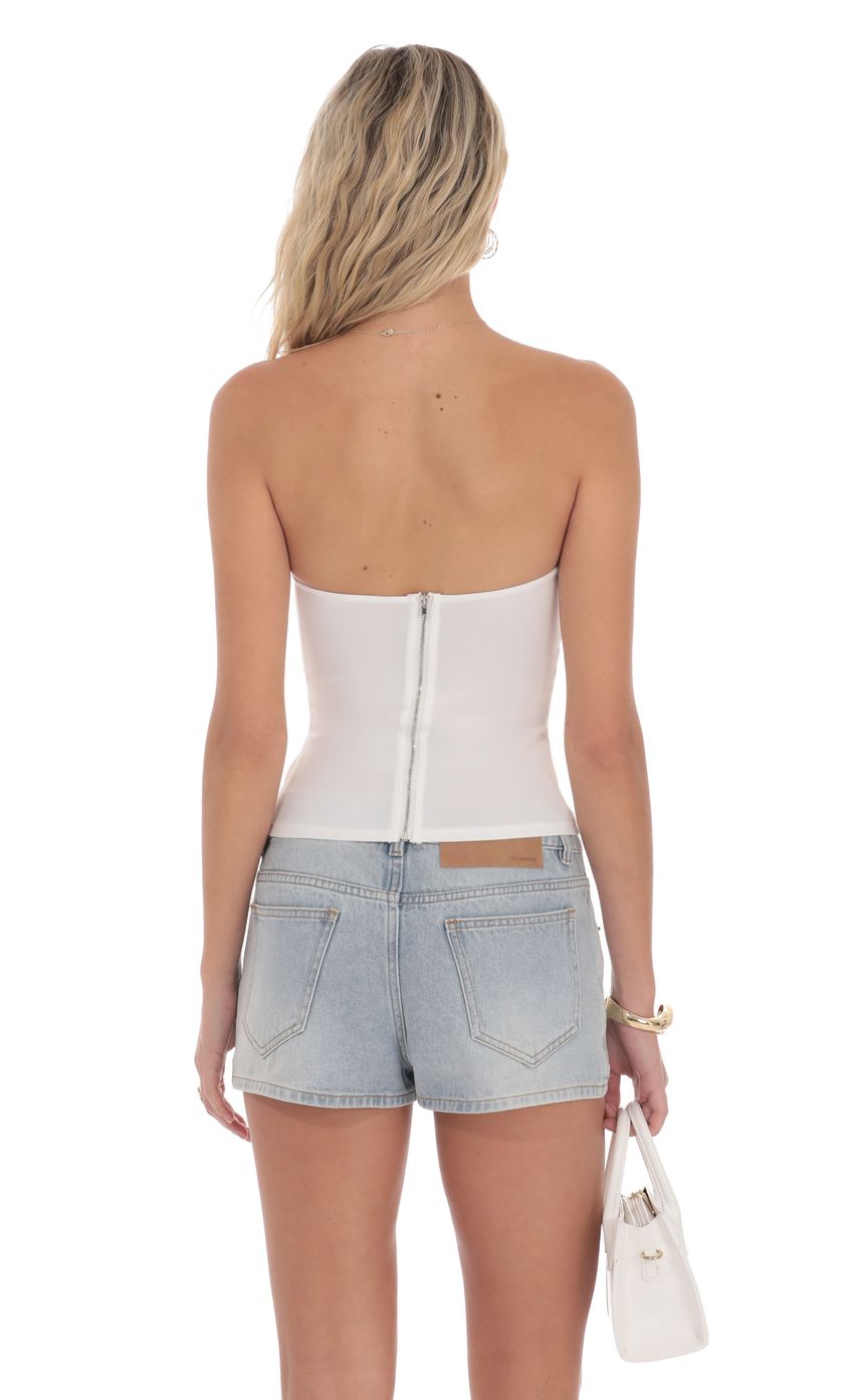 Picture Strapless Buckle Top in White. Source: https://media-img.lucyinthesky.com/data/product-media/850xAUTO/952328eb-8efa-431c-ab96-2a64d634ae66.jpg
