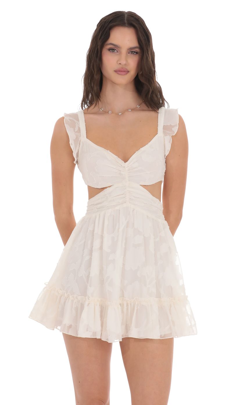 Picture Ruffle Floral Cutout Dress in Cream. Source: https://media-img.lucyinthesky.com/data/product-media/850xAUTO/95a4ff39-713e-460a-b120-eaa4358ce241.jpg