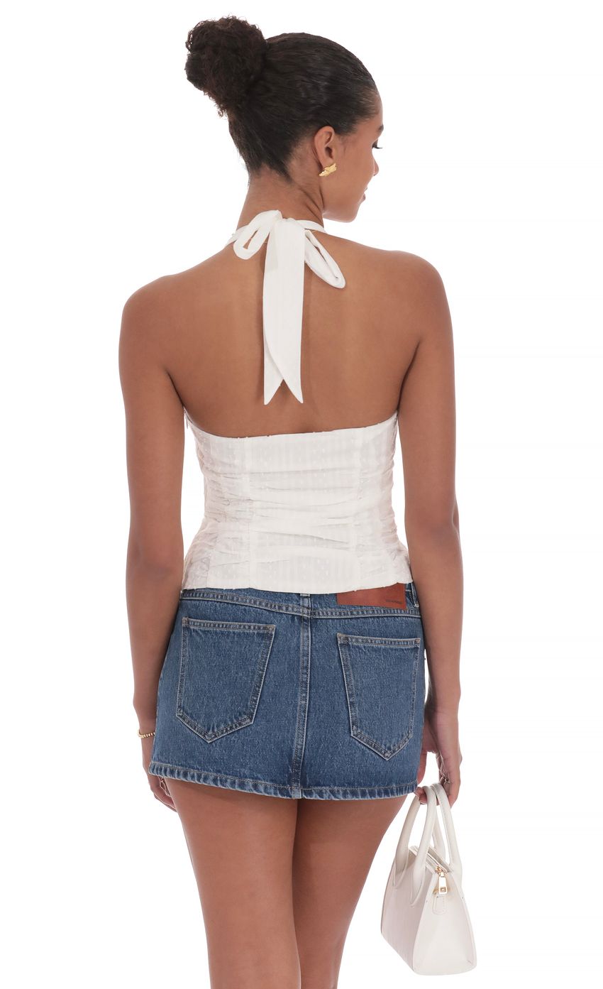 Picture Dotted Halter Top in White. Source: https://media-img.lucyinthesky.com/data/product-media/850xAUTO/99593604-ff3c-449f-988a-194ffb191794.jpg