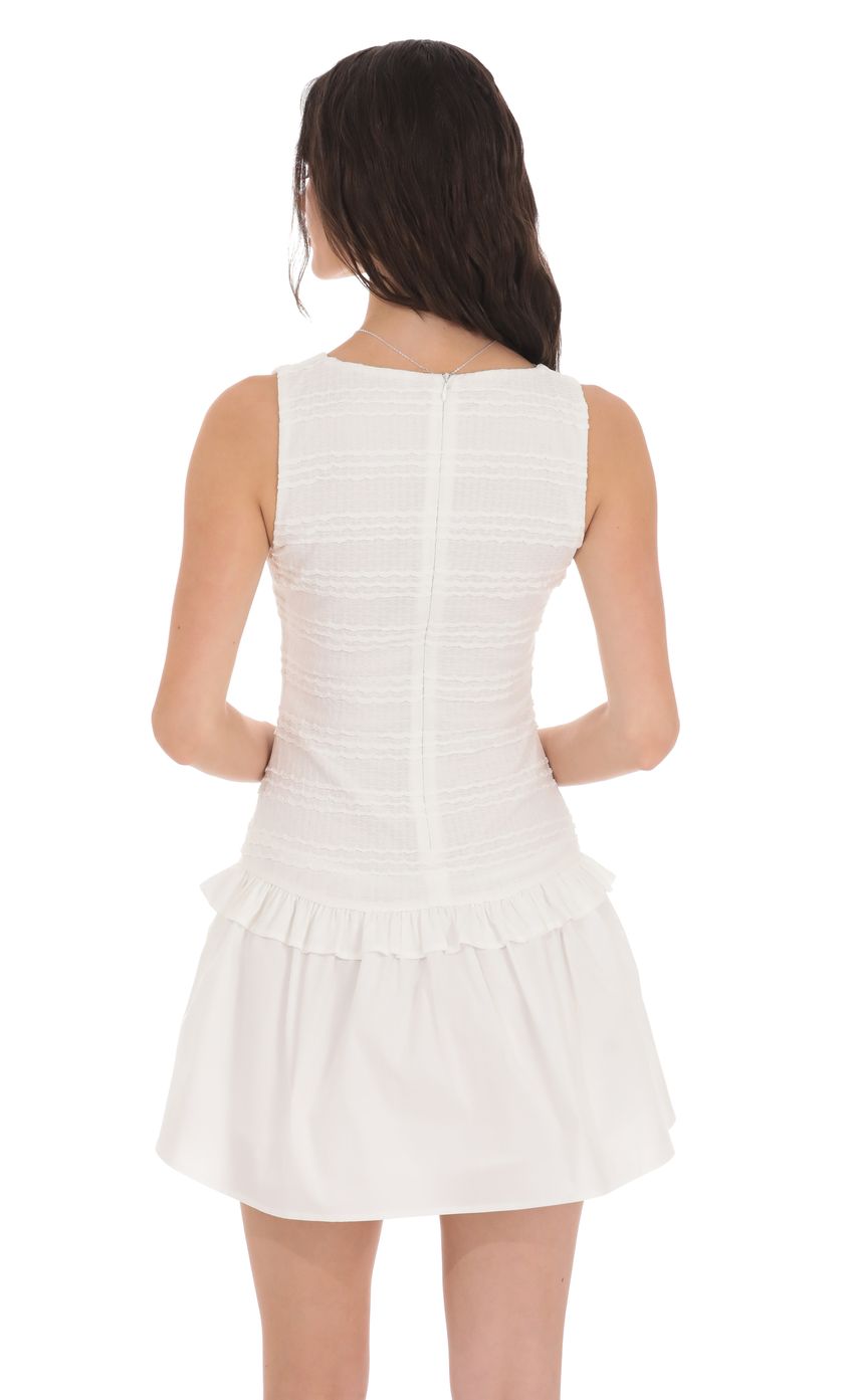Picture Textured High Neck Dress in White. Source: https://media-img.lucyinthesky.com/data/product-media/850xAUTO/a5f5450f-4f2f-4dec-aeb2-b8ff52fe1cba.jpg
