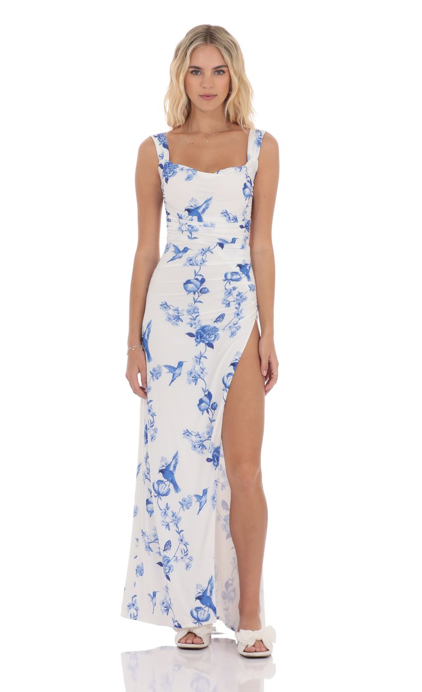 Picture Floral Open Back Bow Maxi Dress in White. Source: https://media-img.lucyinthesky.com/data/product-media/850xAUTO/b077411d-ed57-4087-8c70-5e2bd1e28e51.jpg