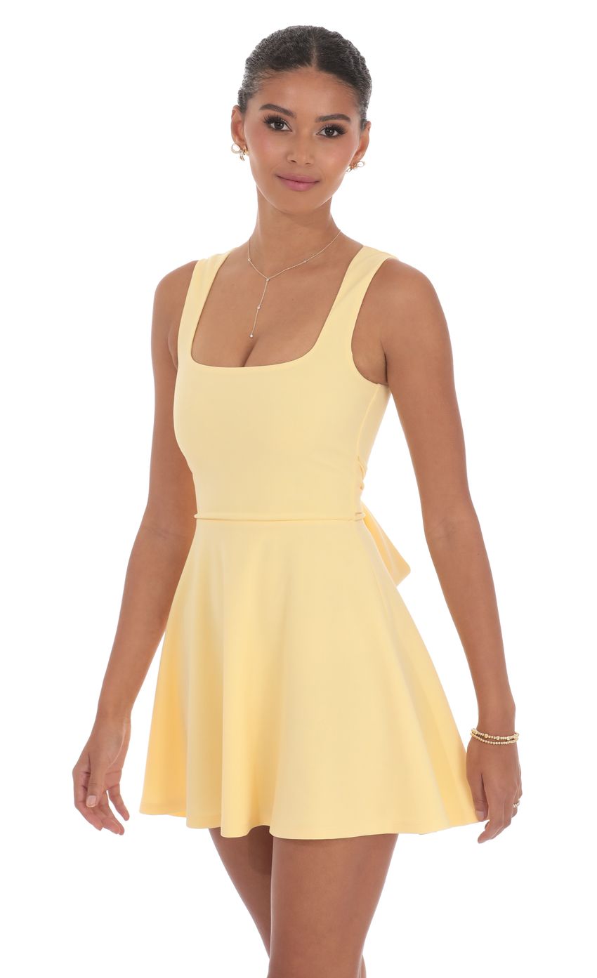 Picture Back Bow A-Line Dress in Yellow. Source: https://media-img.lucyinthesky.com/data/product-media/850xAUTO/b67efcec-3f6c-481b-8f84-3a259969c854.jpg