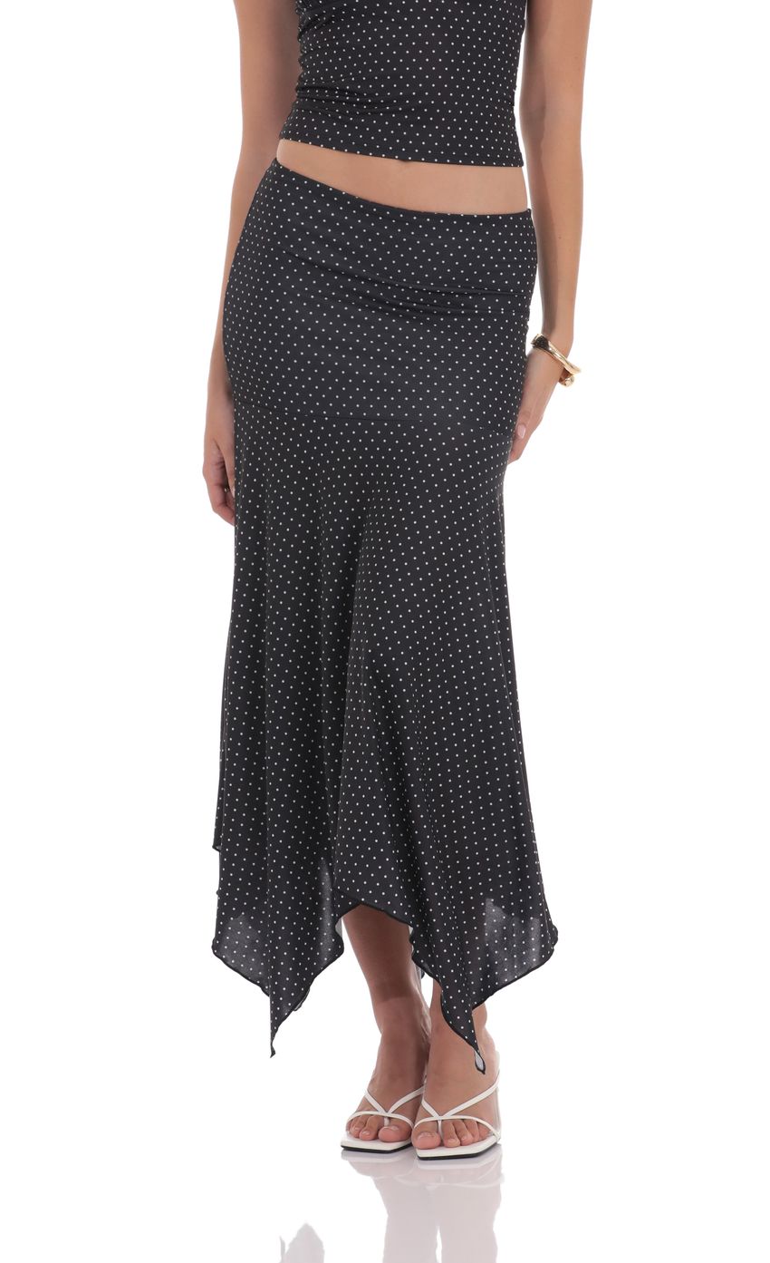 Picture Polka Dot Asymmetrical Maxi Skirt in Black. Source: https://media-img.lucyinthesky.com/data/product-media/850xAUTO/b9cd3eff-fdec-4979-98c9-a2a053bfdc26.jpg