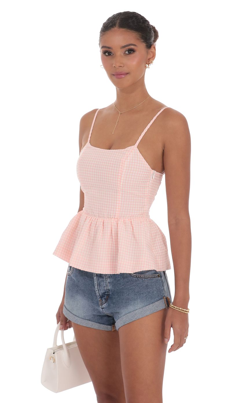 Picture Gingham Peplum Top in Pink. Source: https://media-img.lucyinthesky.com/data/product-media/850xAUTO/bd387da3-c847-44c4-83e9-ff8204db2e80.jpg