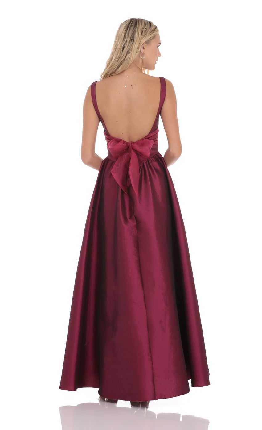 Picture Back Bow Gown in Plum. Source: https://media-img.lucyinthesky.com/data/product-media/850xAUTO/c1732966-5a56-44c7-9245-48eef684333d.jpg
