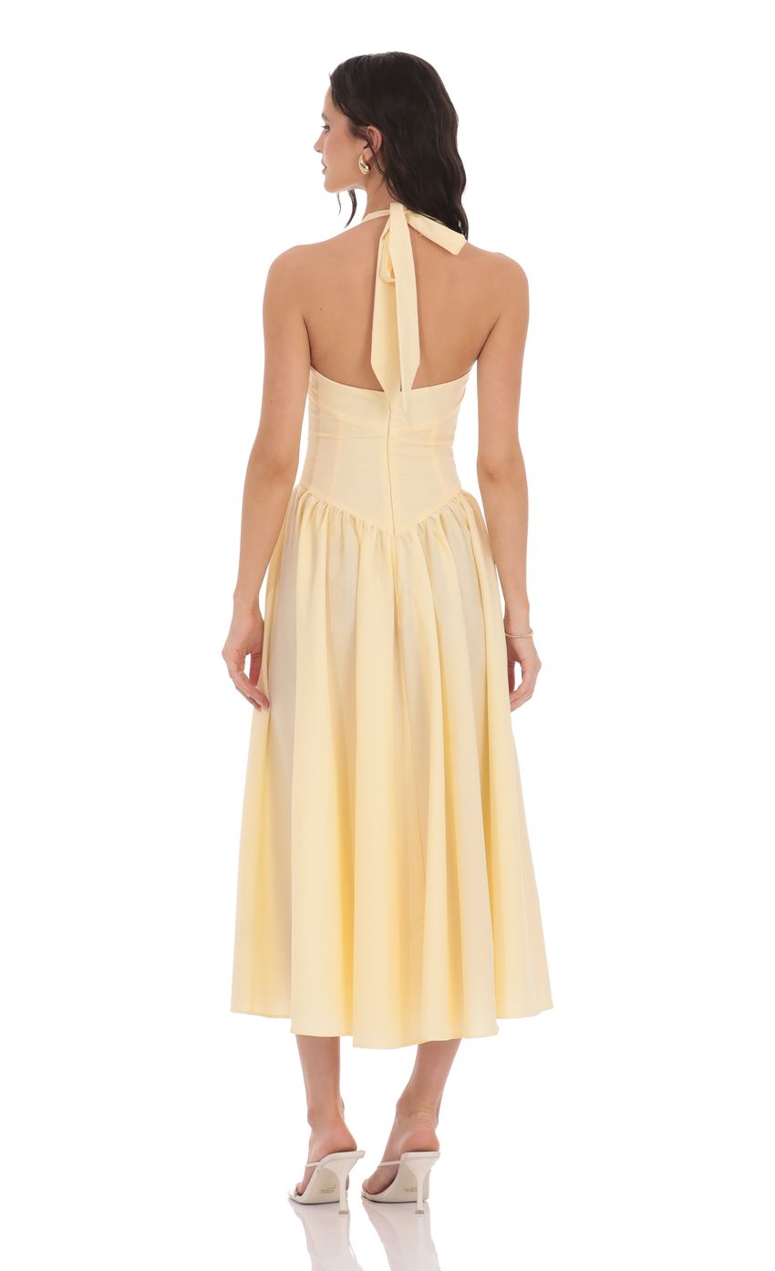 Picture Halter Midi Dress in Yellow. Source: https://media-img.lucyinthesky.com/data/product-media/850xAUTO/c37b54a2-9b83-43ff-abeb-843fd1cf14bb.jpg