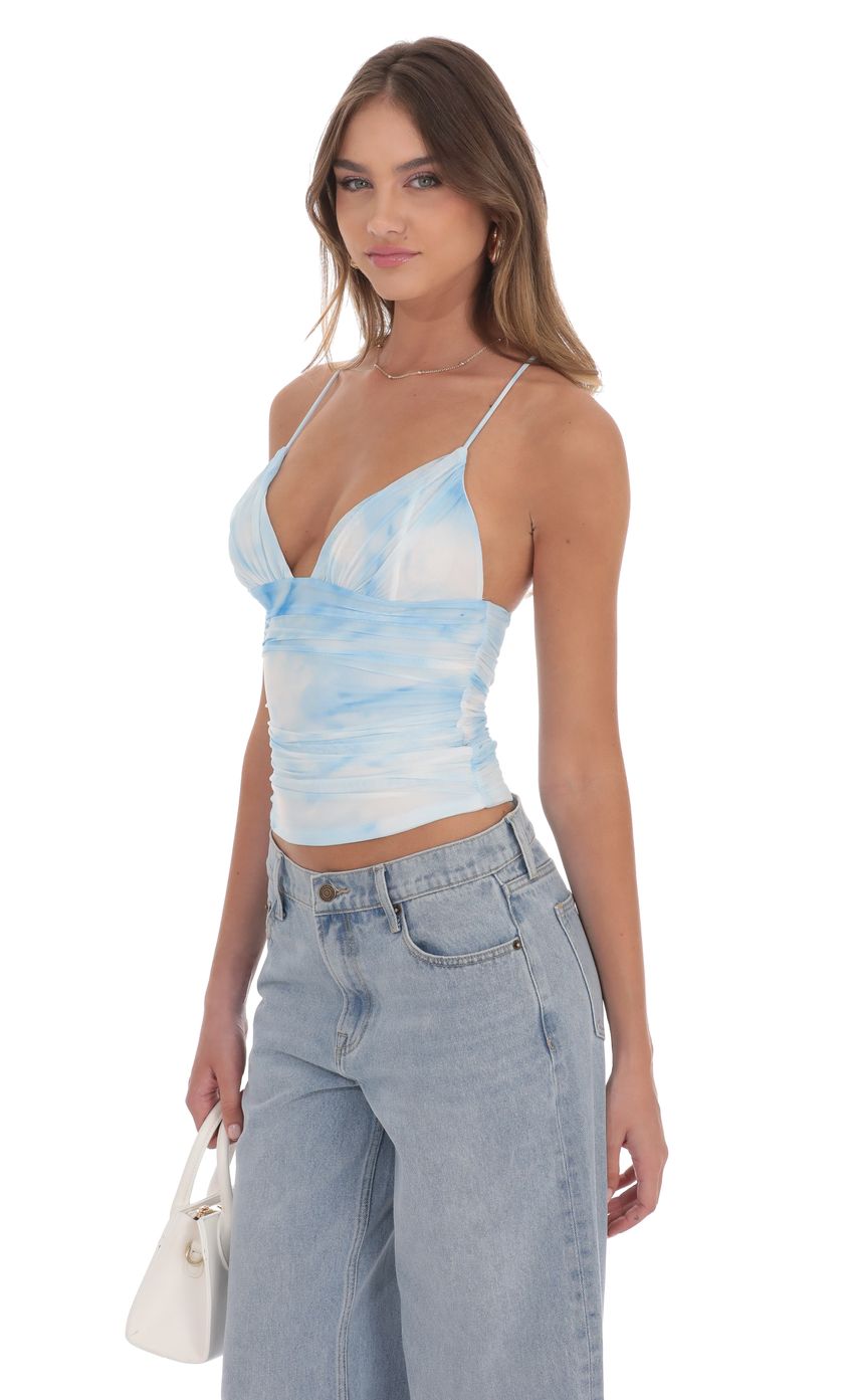 Picture Swirl Mesh V-Neck Top in Blue. Source: https://media-img.lucyinthesky.com/data/product-media/850xAUTO/c4a2d135-79dc-4f9d-b8be-1a5fefb09326.jpg