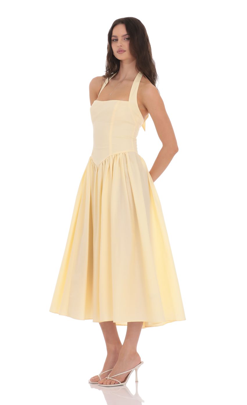 Picture Halter Midi Dress in Yellow. Source: https://media-img.lucyinthesky.com/data/product-media/850xAUTO/c660b7f1-f1d4-4496-b65c-317bf52e4a42.jpg