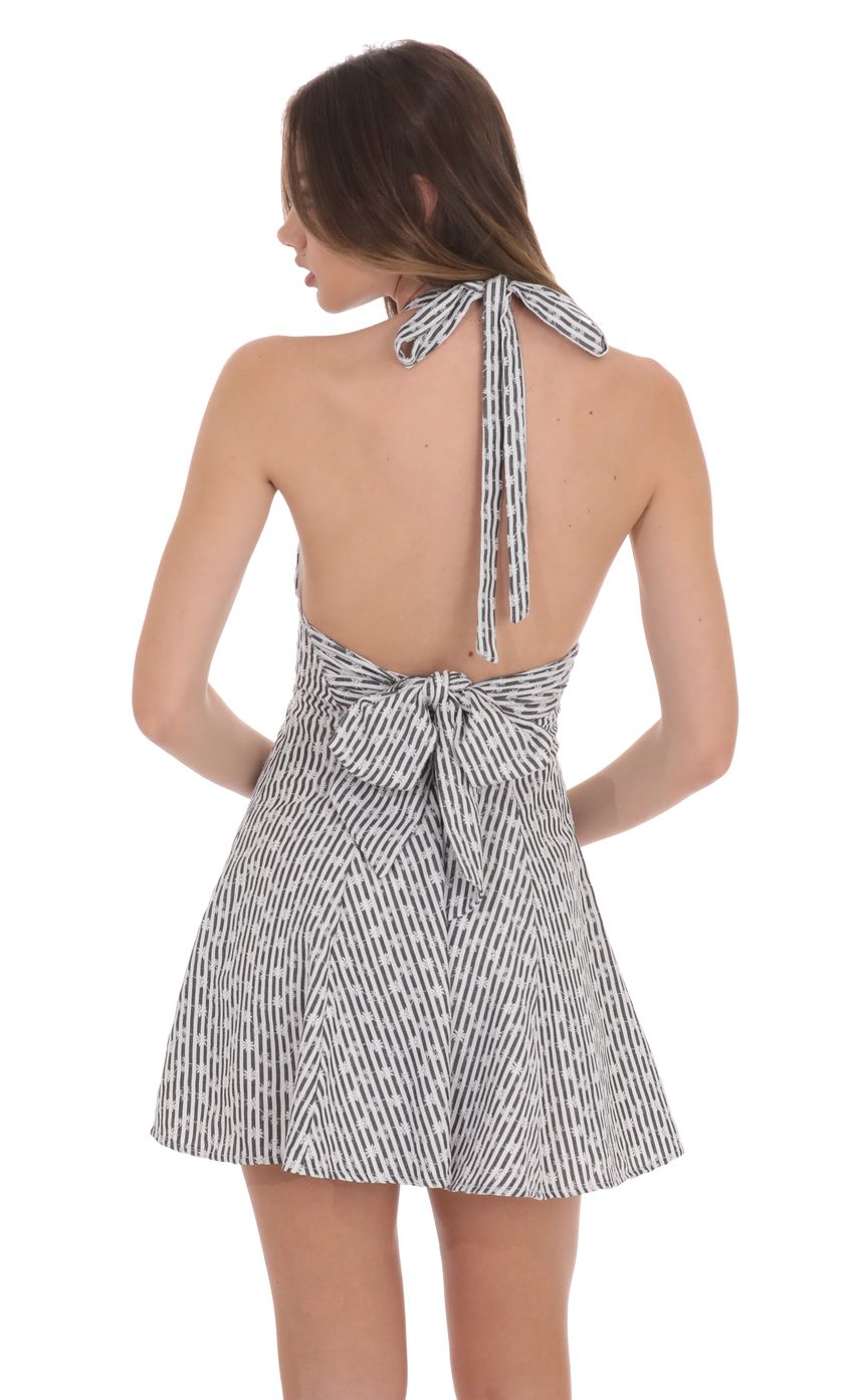 Picture Floral Striped Halter Open Back Dress in Black and White. Source: https://media-img.lucyinthesky.com/data/product-media/850xAUTO/c70e554a-eb8f-4fea-9db7-9c7c2da7e983.jpg
