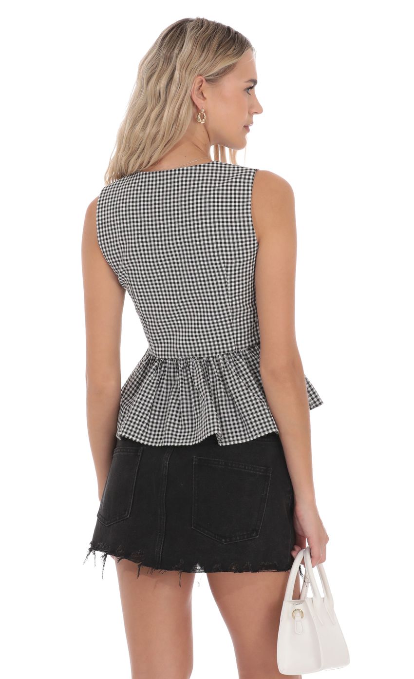 Picture Gingham Peplum Vest in Black and White. Source: https://media-img.lucyinthesky.com/data/product-media/850xAUTO/c8379421-ec16-45ff-a8da-b93dd66666d7.jpg