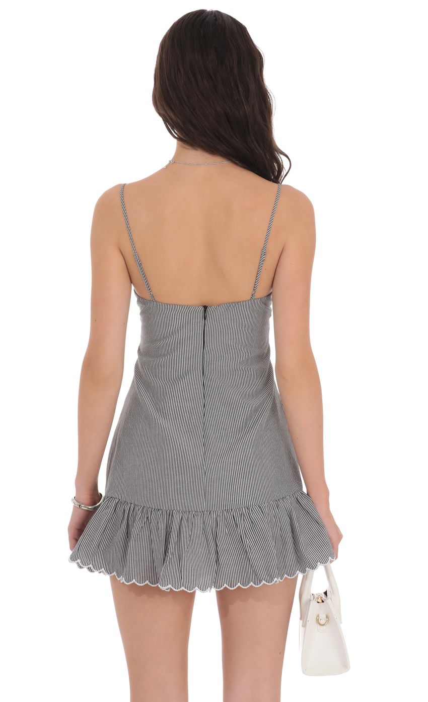 Picture Pinstripe Scallop Ruffle Dress in Grey. Source: https://media-img.lucyinthesky.com/data/product-media/850xAUTO/ca7dd6c0-6af9-402b-a069-9cc15bb18dea.jpg