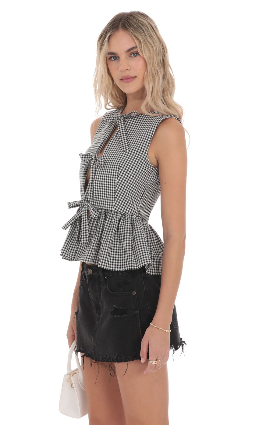 Picture Gingham Peplum Vest in Black and White. Source: https://media-img.lucyinthesky.com/data/product-media/850xAUTO/d0d5a0a8-b8dc-4ad4-95a1-7ca97f6ada28.jpg