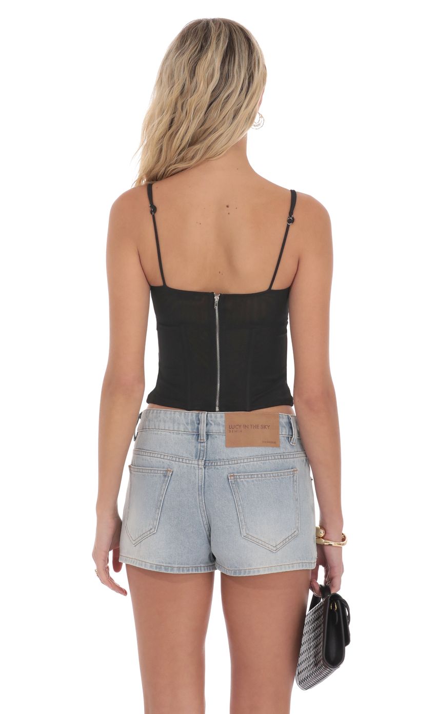 Picture Mesh Twist Corset Top in Black. Source: https://media-img.lucyinthesky.com/data/product-media/850xAUTO/d34d37b6-dd78-4efd-8137-14b705a15d4b.jpg