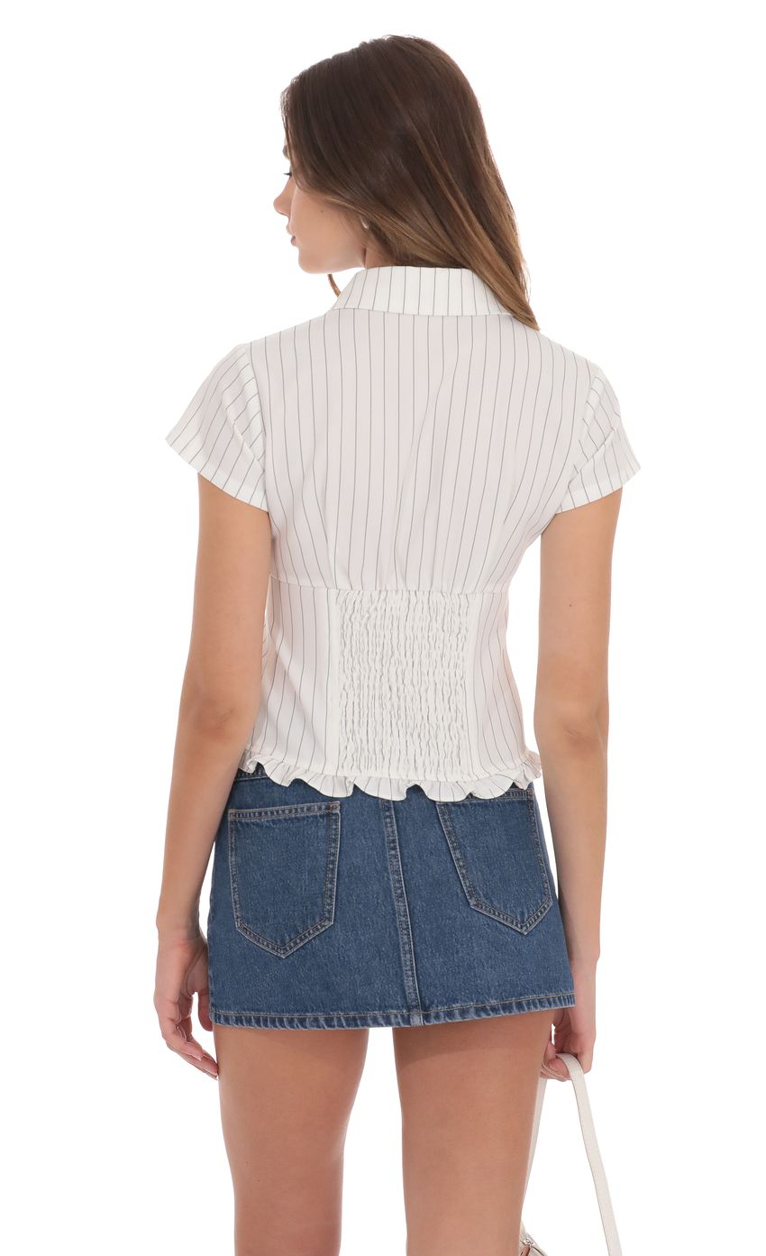 Picture Button-Up Ruffle Top in White Stripes. Source: https://media-img.lucyinthesky.com/data/product-media/850xAUTO/dc4b77b1-b724-46c8-a344-29eb96110bef.jpg