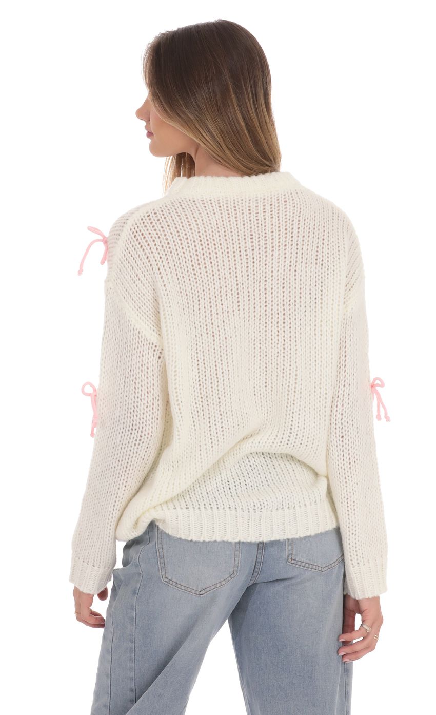 Picture Knitted Bows Jumper in Cream. Source: https://media-img.lucyinthesky.com/data/product-media/850xAUTO/df2a3e9d-20bf-41b2-9852-2ffb72e6097a.jpg