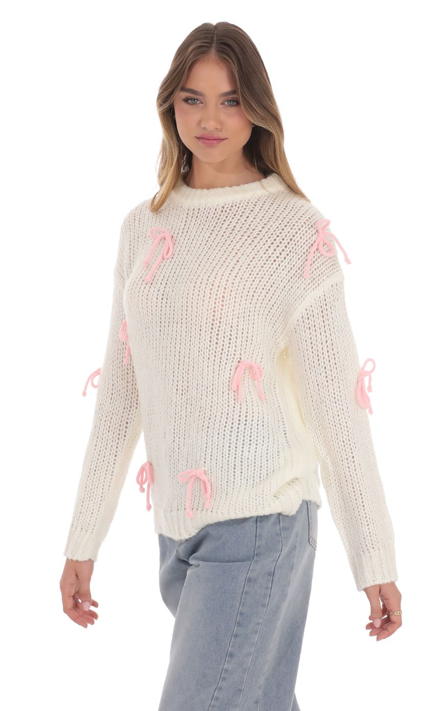 Picture Knitted Bows Jumper in Cream. Source: https://media-img.lucyinthesky.com/data/product-media/850xAUTO/f895cada-0481-490c-9ee4-65b610f668ad.jpg